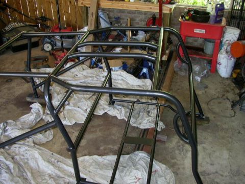 1995 Ford Bronco - A custom roll cage is shown in a garage, covered with white cloths.