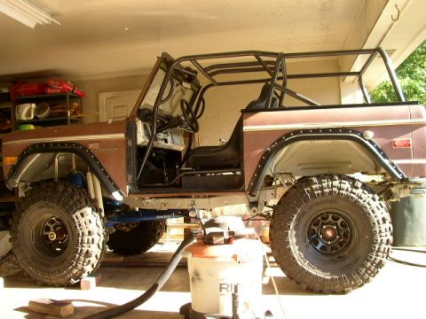 1995 Ford Bronco - This modified Ford Bronco features a custom roll cage and lifted suspension, indicating it is not a 1995 model.
