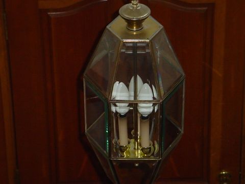 1998 Ford Crown Victoria - A close-up view of a decorative lantern with glass panels and brass accents.