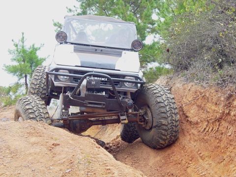 1978 Ford Bronco - This modified Suzuki Samurai navigates a challenging off-road course with its large tires and lifted suspension.