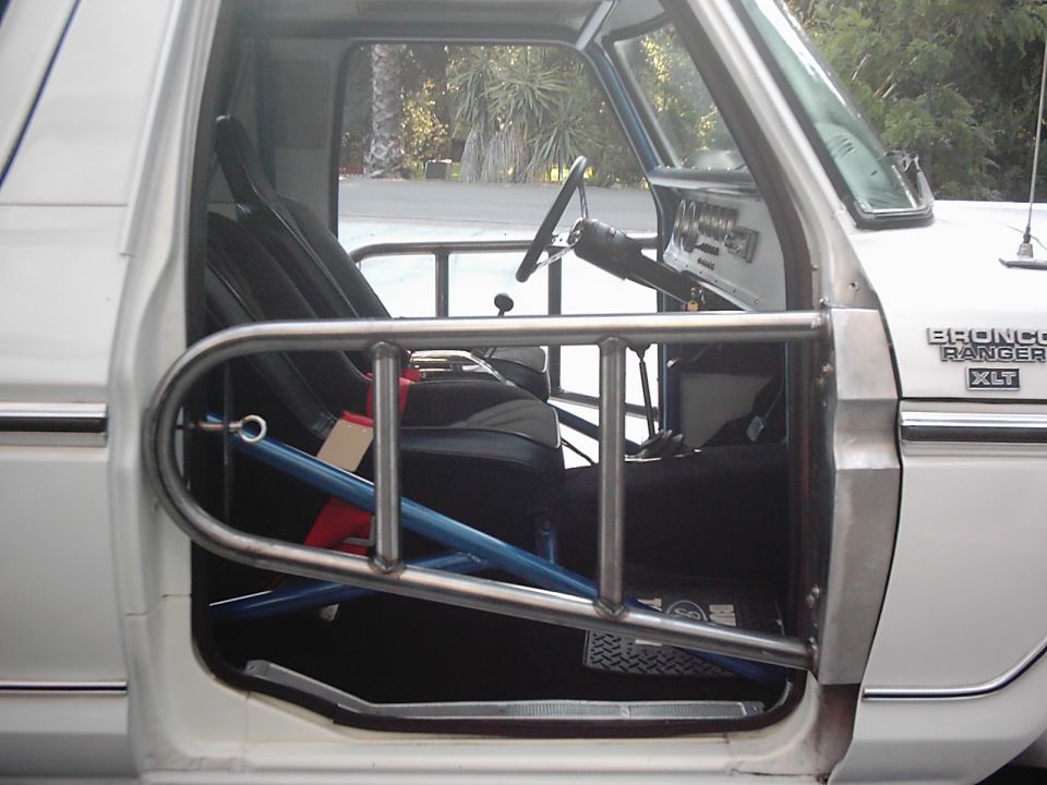 Interior of Ford Bronco Ranger XLT with tube door and roll cage, white body