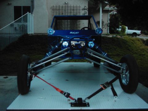 1978 Ford Bronco - A custom blue buggy is secured to a trailer, ready for transport.