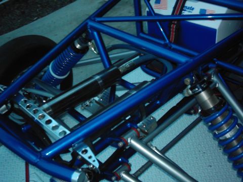 1978 Ford Bronco - Close-up view of a custom-built race car's blue tubular chassis and suspension system.