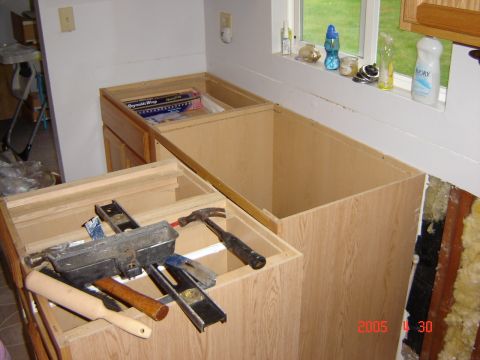1993 Ford Bronco - Tools are laid out on unfinished kitchen cabinets during a renovation project.