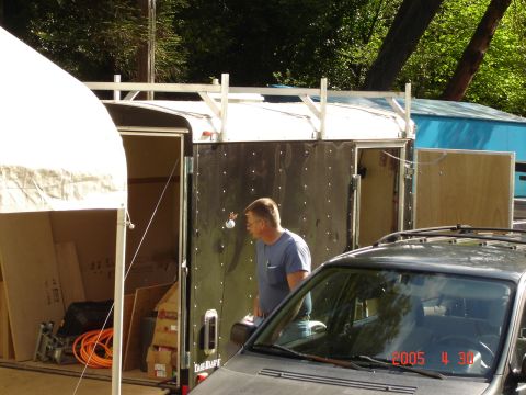 1993 Ford Bronco - A dark SUV is partially visible in the foreground, with a trailer and a man in the background.