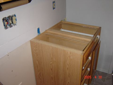 1993 Ford Bronco - Kitchen cabinets are being installed, showing exposed wood and electrical wiring on the wall.