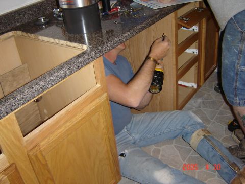 1993 Ford Bronco - A person works on kitchen cabinets during a renovation project.