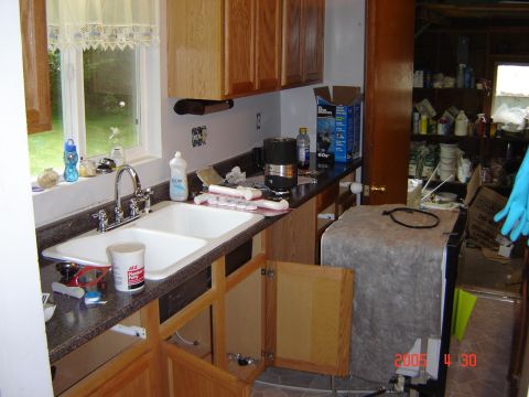 1993 Ford Bronco - This photo shows a kitchen undergoing renovation, with exposed cabinets and various items on the countertop.