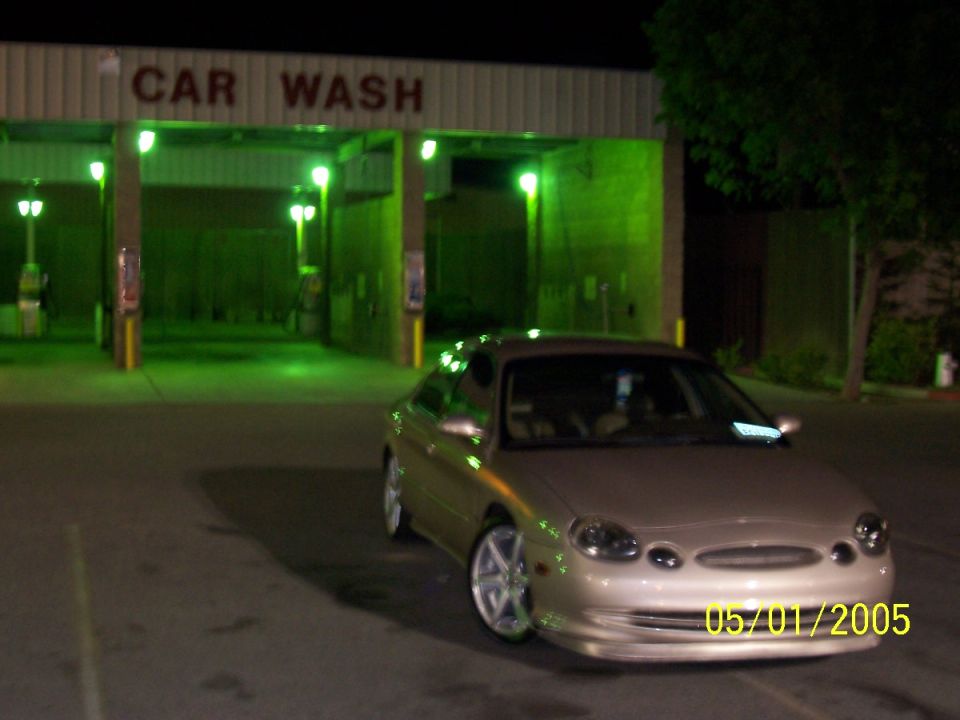 Gold 1998 Mercury Sable sedan parked at a car wash
