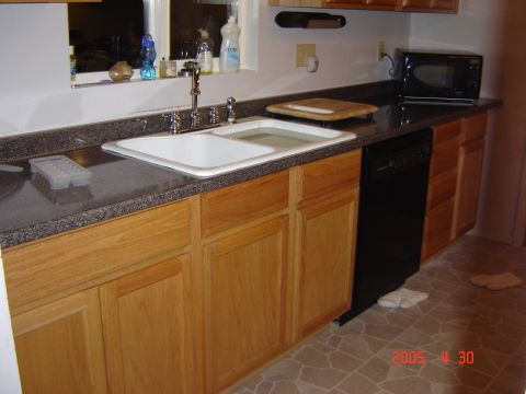 1993 Ford Bronco - A view of a kitchen sink, wooden cabinets, and a black dishwasher, with a watermark indicating it was posted in 2005.