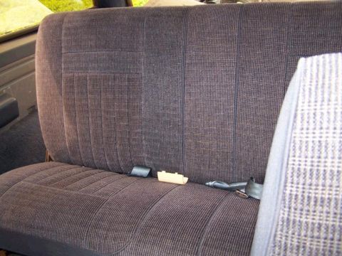 1988 Ford Bronco - Interior view of a vehicle's rear seat, showing fabric upholstery and seatbelts.