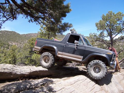 1991 Ford Bronco - This modified SUV navigates a rocky trail, its off-road capabilities.