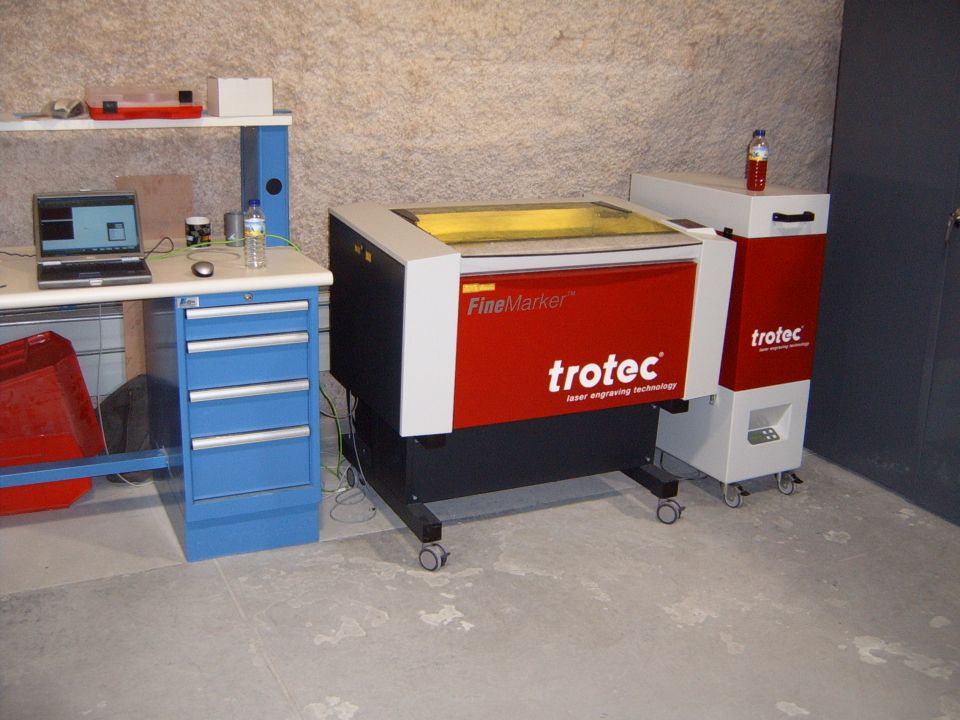 Red and white laser engraver with 'trotec' logo
