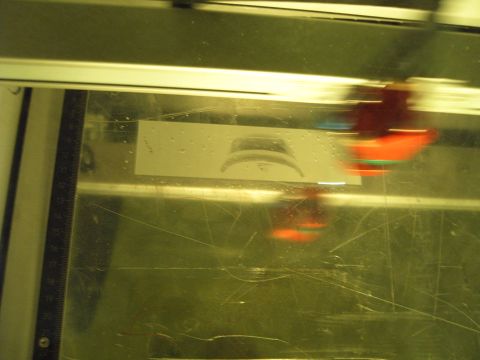 1988 Ford Bronco - Close-up of a laser engraving machine head in motion over a stencil.