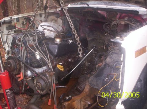 1985 Ford Bronco - Engine removal in progress, showing the engine bay and mechanical components.