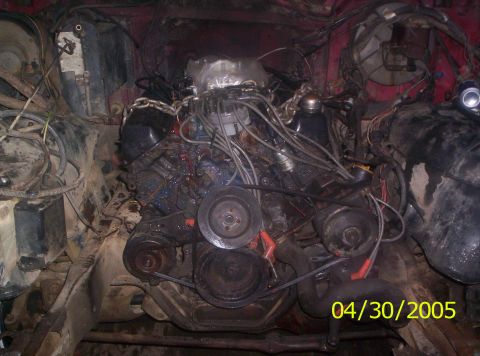 1985 Ford Bronco - The engine bay of a vehicle is shown with a V8 engine and associated components.