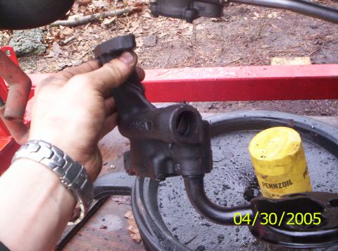 1985 Ford Bronco - Oil pump and filter removed from a vehicle for maintenance.