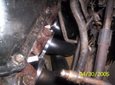 1985 Ford Bronco - Close-up view of an engine bay, highlighting the exhaust manifold and a spark plug, with a timestamp of 04/30/2005.