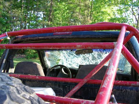 1985 Ford Bronco - This vehicle has a custom roll cage and a heavily damaged windshield, suggesting off-road use.