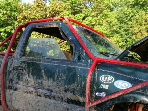 1985 Ford Bronco - This heavily modified truck shows signs of damage and off-road use.