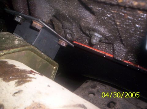 1985 Ford Bronco - Undercarriage view of a vehicle's engine mount and surrounding components.