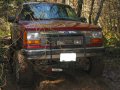 1991 Ford Explorer - Front view of a 1991 Ford Explorer with a chrome brush guard, parked outdoors.