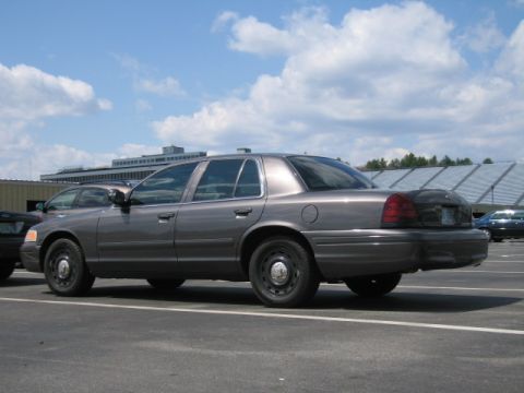 1991 Ford LTD Crown Victoria - A 1991 Ford Crown Victoria LTD sedan is parked in a lot under a cloudy sky.