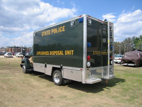 1991 Ford LTD Crown Victoria - A dark green truck with yellow lettering identifies itself as the State Police Explosives Disposal Unit.