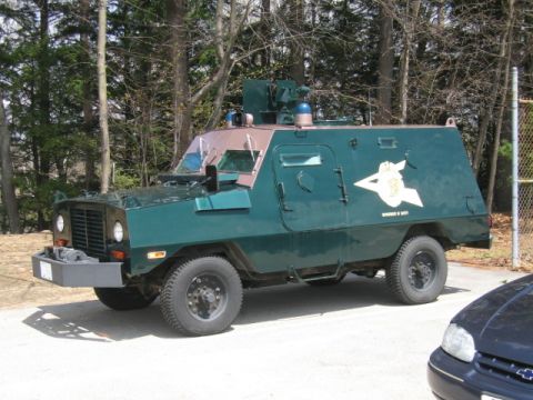 1991 Ford LTD Crown Victoria - This armored vehicle, marked with "Department of Safety," is seen in a wooded area.