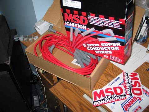 1995 Ford Bronco - MSD ignition wires and box with promotional stickers on a desk.