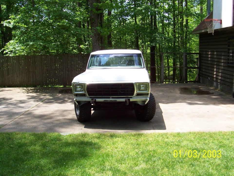 White 1979 Ford Bronco front view with black grille and large tires