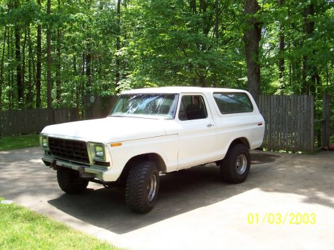 1979 Ford Bronco - This 1979 Ford Bronco is parked on a driveway with a wooded area in the background.