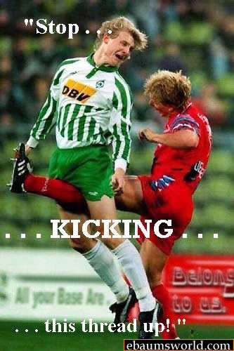 1991 Ford Bronco - Two soccer players are engaged in a game, with one player in mid-kick towards the other.