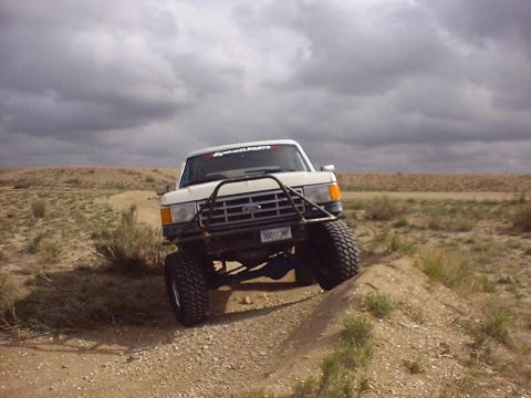1988 Ford Bronco - This modified 1988 Ford Bronco navigates an off-road course under a cloudy sky.