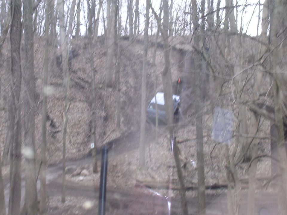 1995 Jeep Cherokee driving on a wooded dirt trail