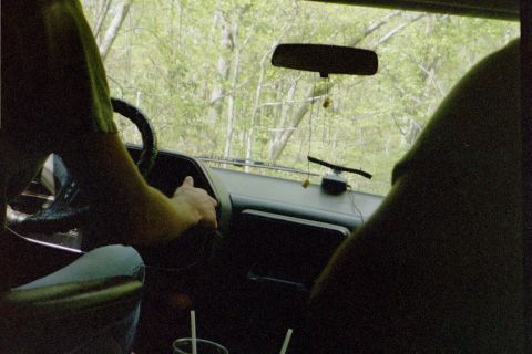 1988 Ford Bronco - View from inside a vehicle as it drives through a wooded area.