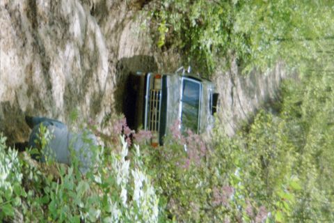1988 Ford Bronco - 1988 Ford Bronco resting on its side after going off the road.