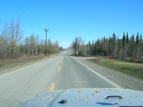2003 Jeep TJ - Driving on a dusty road with trees and power lines visible.