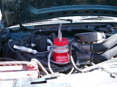 1996 Ford Bronco - Custom siphon attachment made for draining most of tranny fluid. Mity Vac pump with Folgers coffee bottle, real hi-tech eh?