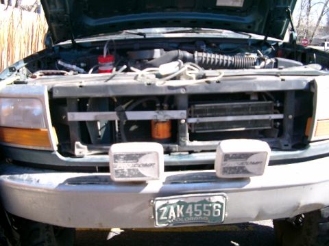 1996 Ford Bronco - Origianal setup about to be removed due to hole in tranny cooler. Note oil filter setup. The hot fluid from the tranny goes into the oil fi…
