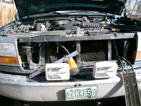 1996 Ford Bronco - Old tranny cooler removed, note custom bracket made out of 1/8" x 1 1/2" aluminum to mount the cooler to. Small cooler on right is for powe…