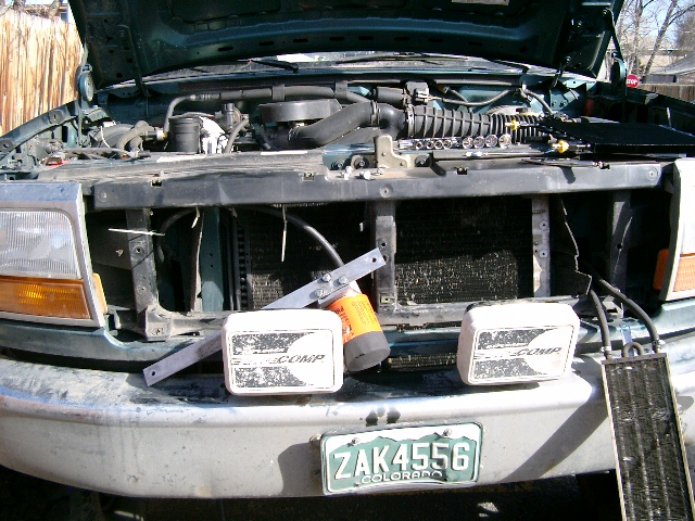 Old tranny cooler removed, note custom bracket made out of 1/8" x 1 1/2" aluminum to mount the cooler to.  Small cooler on right is for power steering fluid.