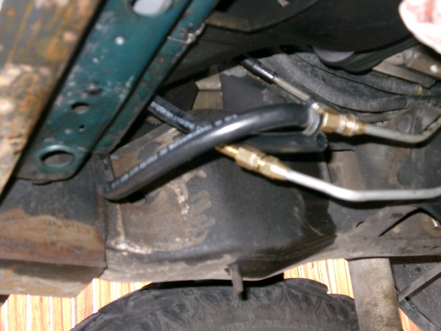 Detail of how I adapted the tranny cooler lines from the tranny.  I used 5/16" flare fitting to 5/16" to 1/4" male fitting.  Then a 1/4" to 3/8" hose barb.  This line goes to the filter first then to the bottom of the tranny cooler.  Then from the top of the cooler to the tranny.