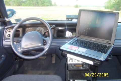 1998 Ford Crown Victoria - Interior view of a 1998 Ford Crown Victoria, equipped with a laptop and police radio equipment.