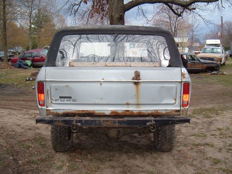 1979 Ford Bronco - This 1978 Ford Bronco is seen from the rear, with other vehicles in a yard.
