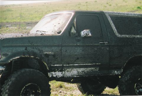 1992 Ford Bronco - This 1992 Ford Bronco is heavily covered in mud, suggesting it was used for off-roading.