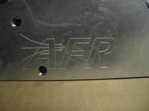 1981 Chevrolet Corvette - This is a close-up of an aluminum part with the AFR logo and airflow graphics etched into the surface.