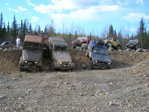 2003 Jeep TJ - Multiple off-road vehicles are shown traversing a challenging rocky terrain.