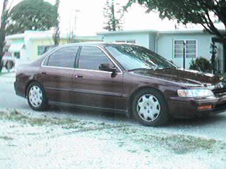 1993 Ford Bronco - This maroon Honda Accord sedan is shown from the driver's side in a three-quarter front view.