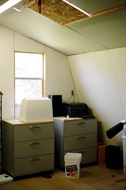 1976 Ford F-150 - A room interior shows filing cabinets, a window, and office equipment, with a bucket of cleaning product visible.
